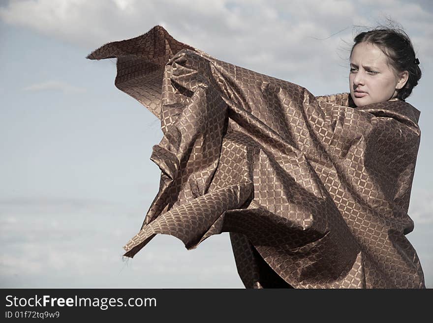 Sky and woman with gold textile. Sky and woman with gold textile