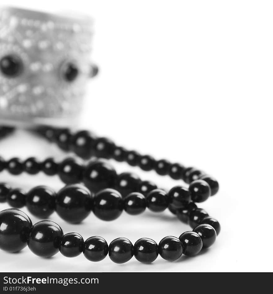 Bracelet and black necklace closeup on a white background. Bracelet and black necklace closeup on a white background