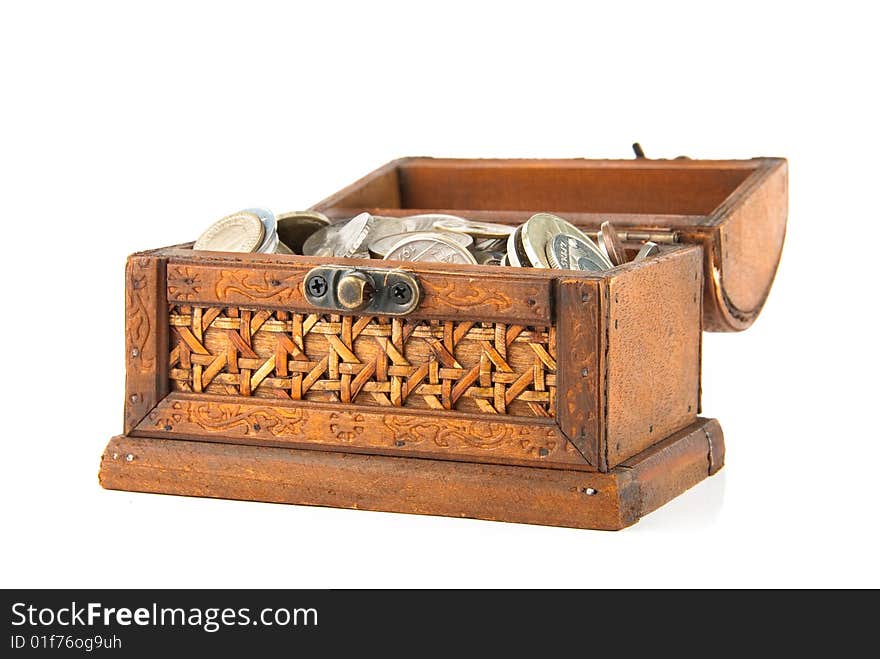 Open wooden chest with lot of coins inside. Isolated over white. Open wooden chest with lot of coins inside. Isolated over white.