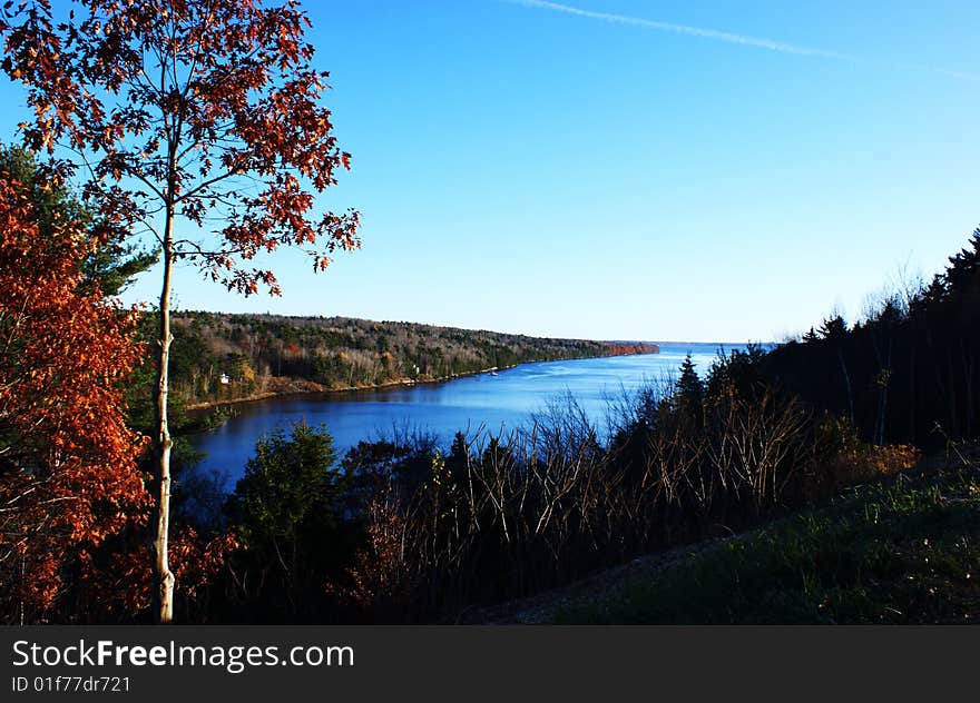 Great view of river framed with colorful oaks, trees, fall colors and a beautiful early evening sky. Great view of river framed with colorful oaks, trees, fall colors and a beautiful early evening sky.