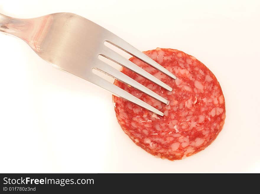 Piece of the sausage on the fork