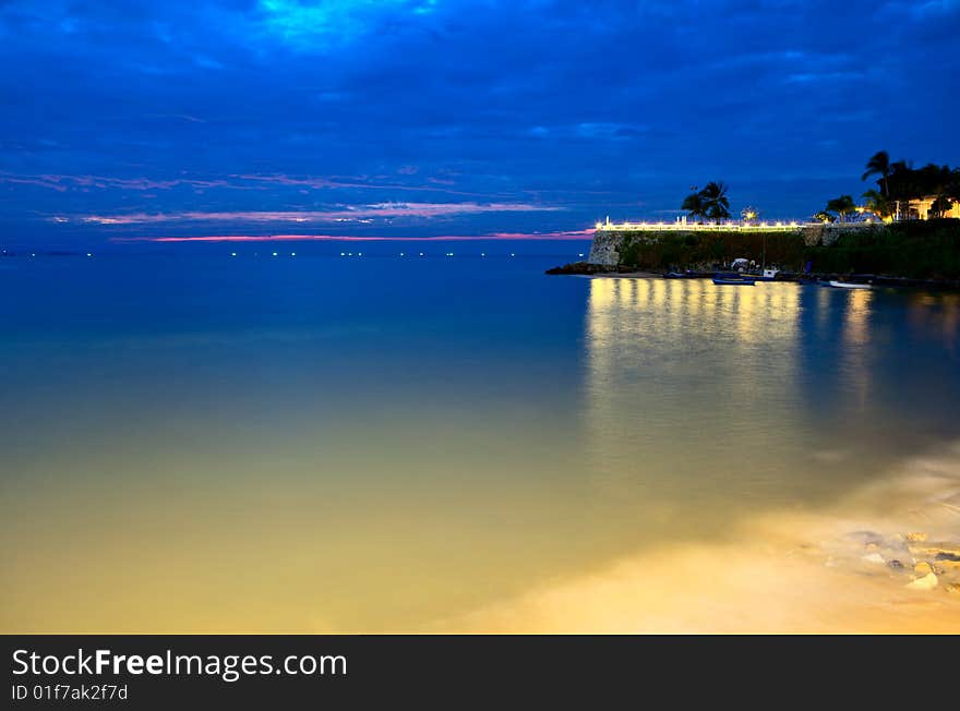 Nightly lights, the sea and hotel on the rock. Nightly lights, the sea and hotel on the rock