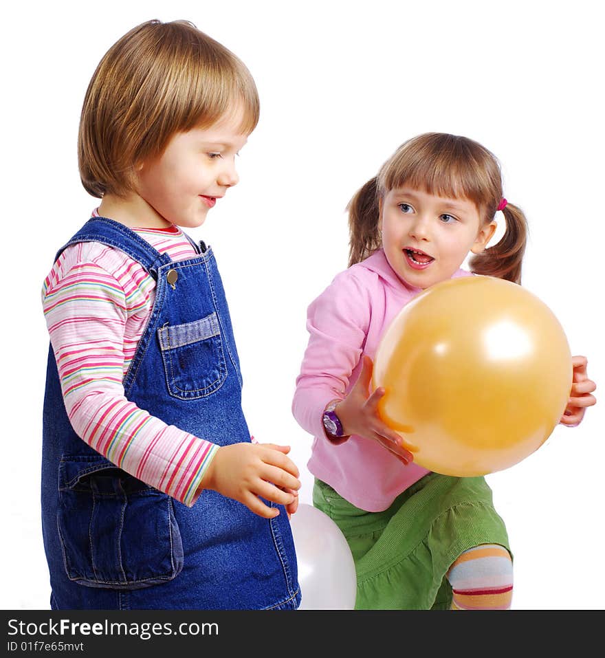 Two girls playing air balloons. studio shot