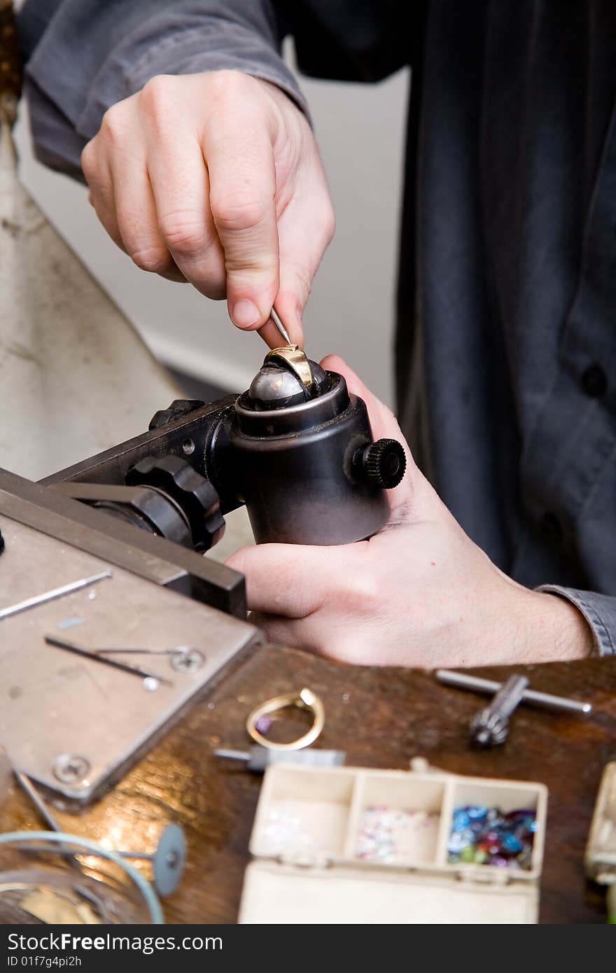 Goldsmith work in process. The goldsmith put a stone into the ring.