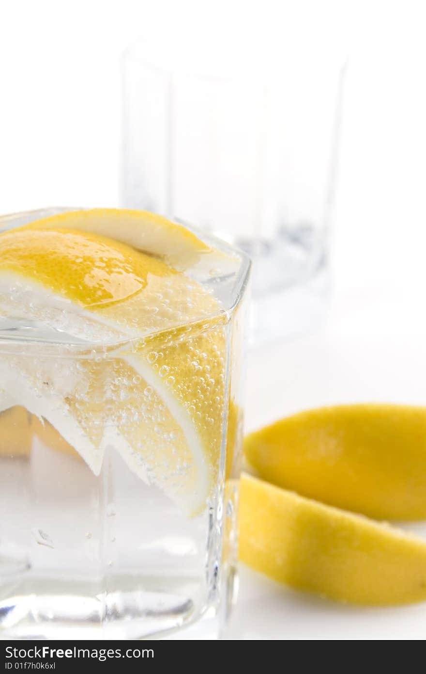 Glass with soda water and lemon slices