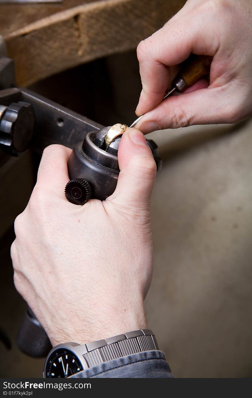 Goldsmith work in process. The goldsmith put a stone into the ring.