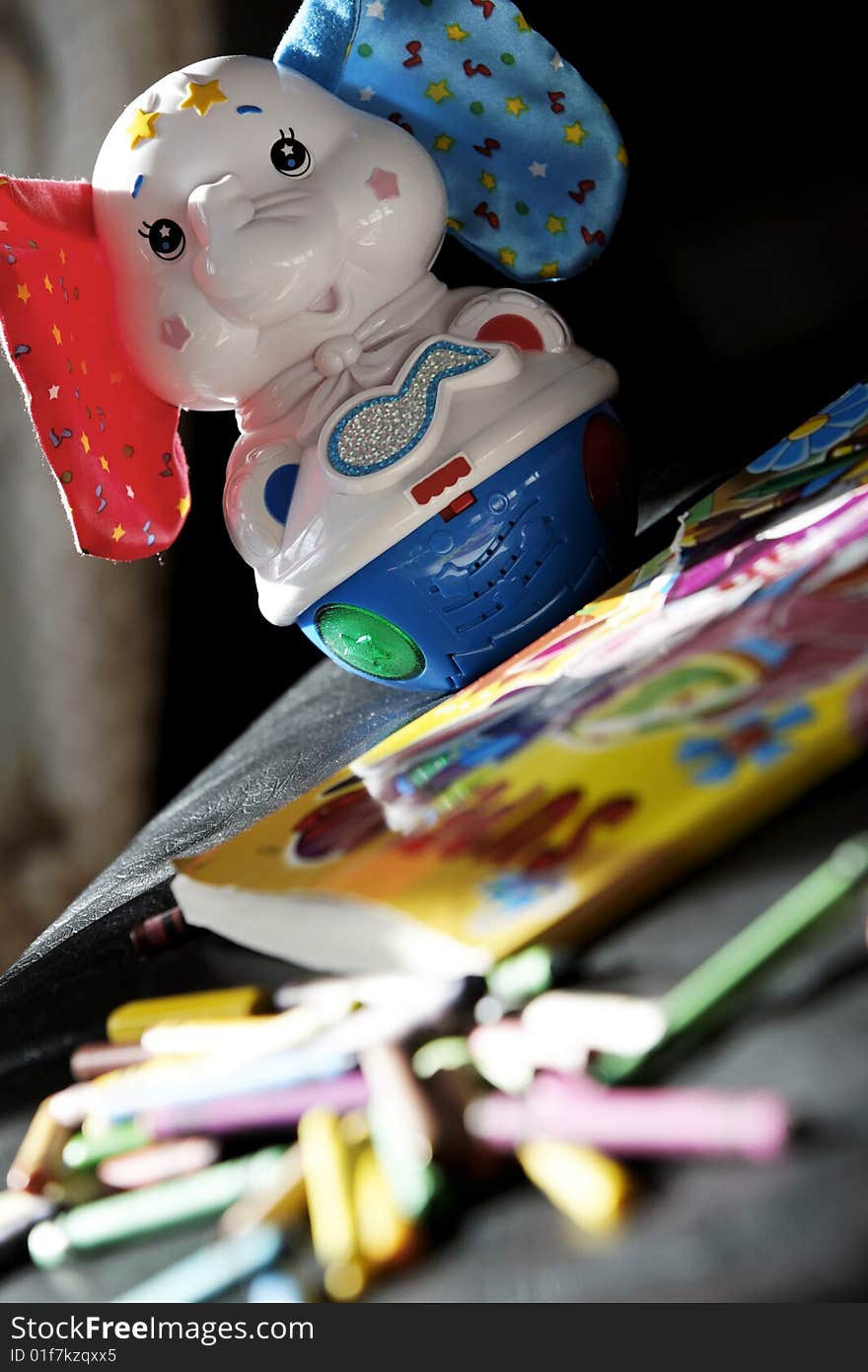 Toy,book and pencil with selective focus. Toy,book and pencil with selective focus