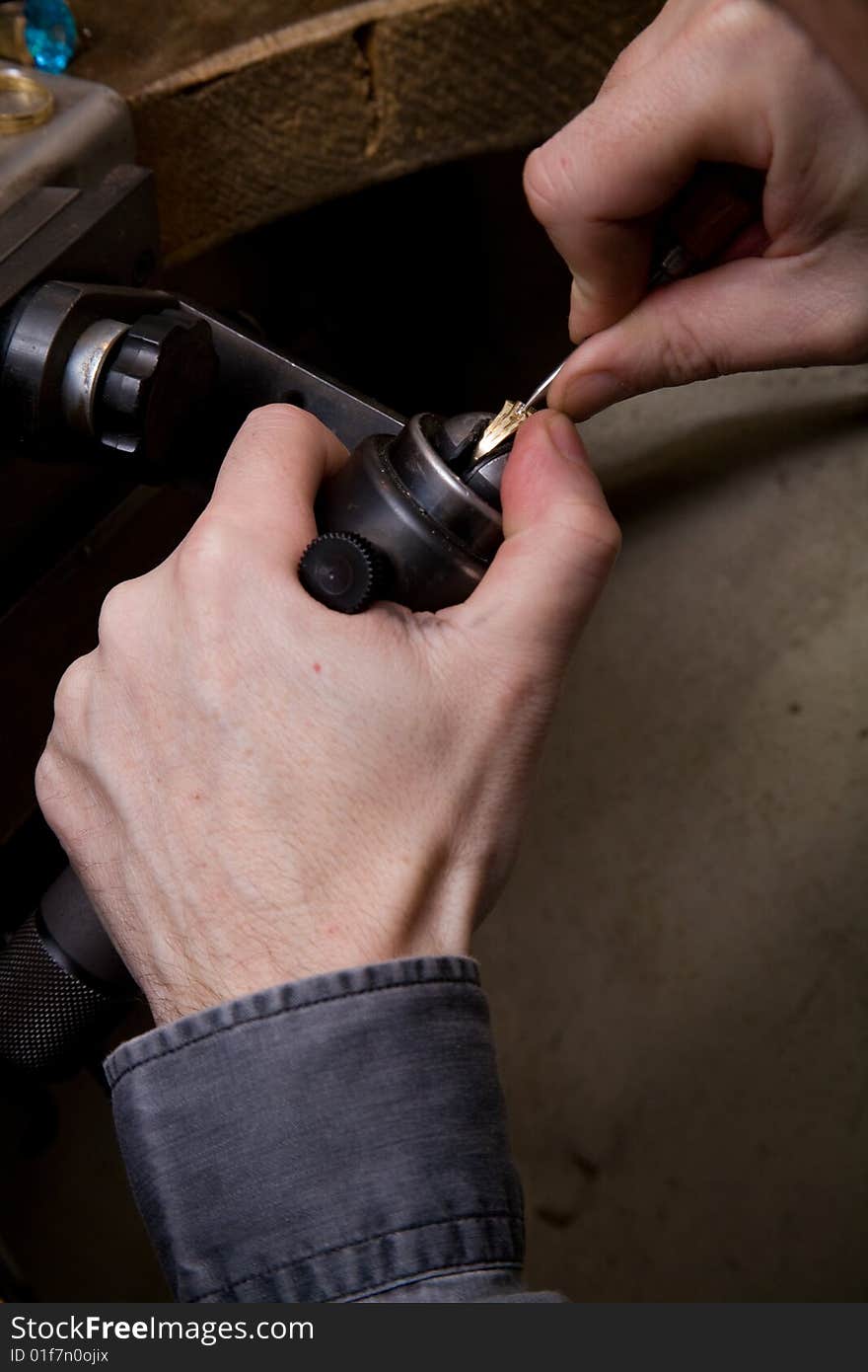 Goldsmith work in process. The goldsmith put a stone into the ring.