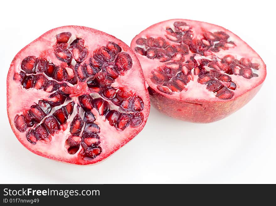 A fresh halved Pomegranate isolated on white