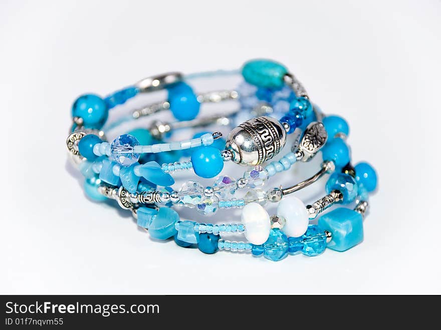 Blue bracelet on white background with turquoise and moonstone