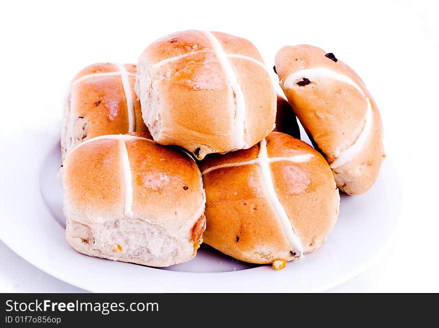 A plateful of fresh hot cross buns. A plateful of fresh hot cross buns