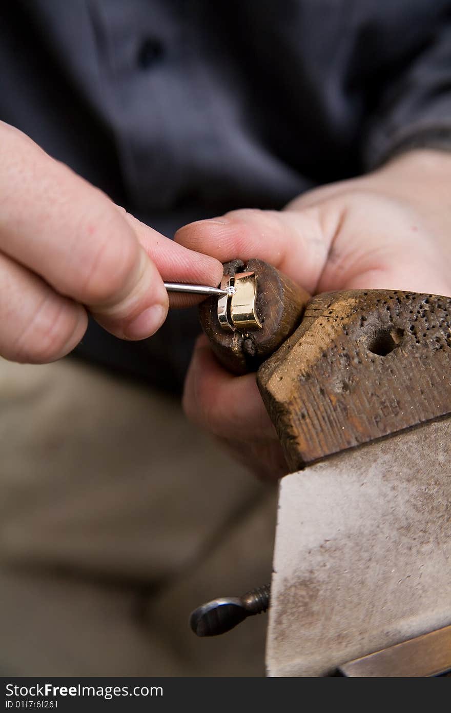 Goldsmith work in process. The goldsmith put a stone into the ring.