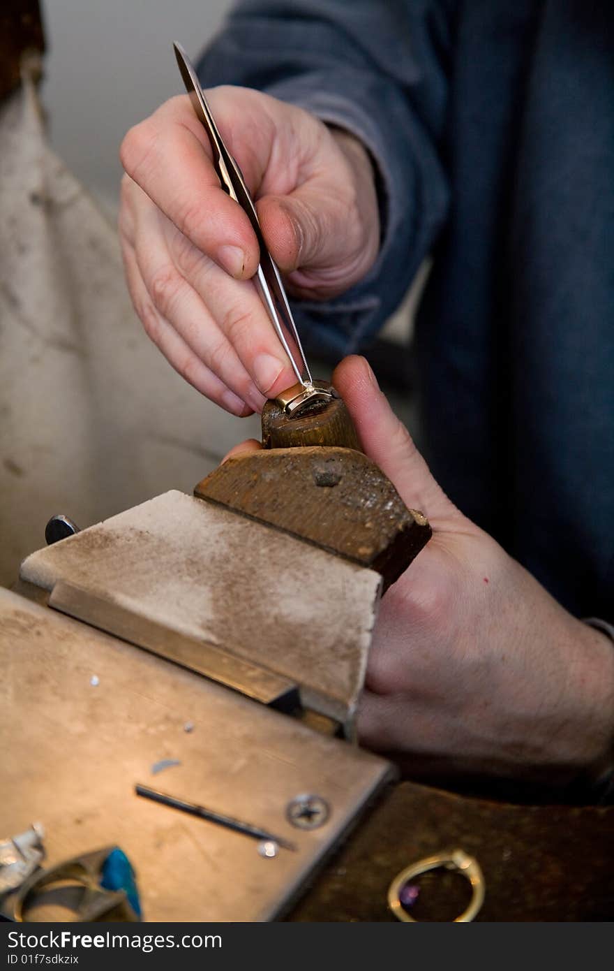 Goldsmith work in process. The goldsmith put a stone into the ring.