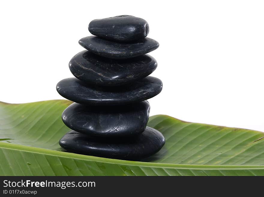 Black Stones on banana leaf. Black Stones on banana leaf