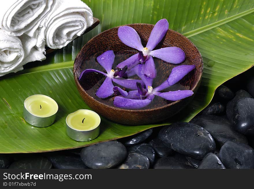 Orchid and stones on banana leaf. Orchid and stones on banana leaf