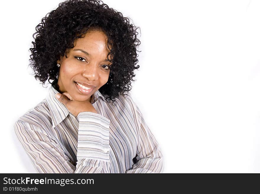 A friendly African American girl smiles at the camera in front of a white background. A friendly African American girl smiles at the camera in front of a white background