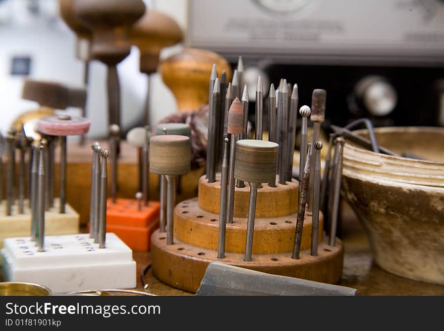 Goldsmith tools and rings on the goldsmith workplace, desktop