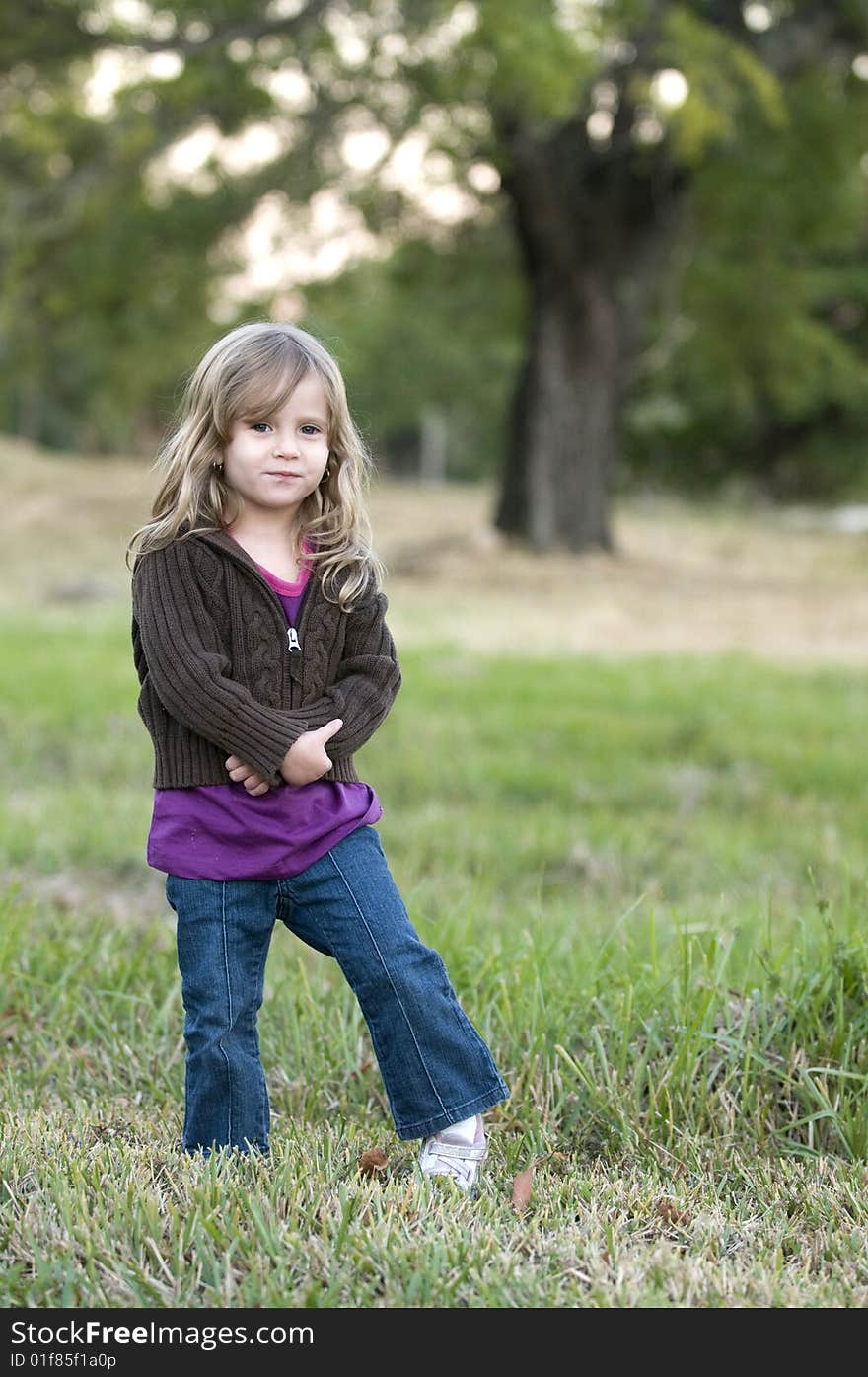 Girl in Field with a tree in depth of field