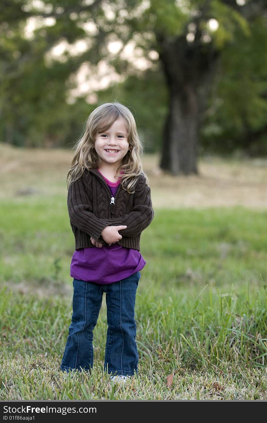 Girl in a Field Smiling at the camera