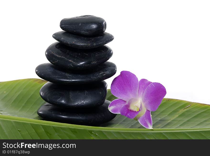 Pink Orchid and stones on banana leaf. Pink Orchid and stones on banana leaf