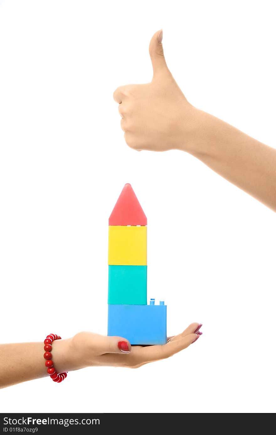 Two people making a toy house, against white background