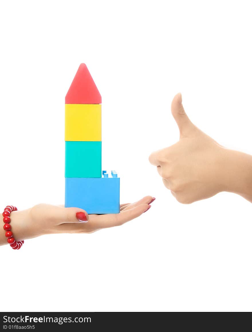 Two people making a toy house, against white background