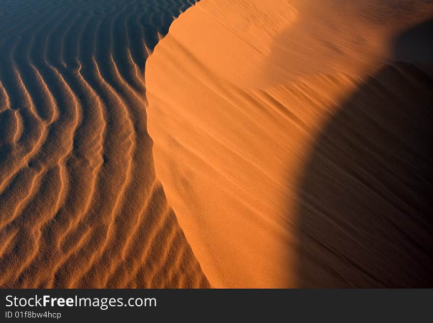 Sand dunes during sunset, dramatic shadow play at Stockton dunes in Anna Bay, NSW, Australia. Sand dunes during sunset, dramatic shadow play at Stockton dunes in Anna Bay, NSW, Australia