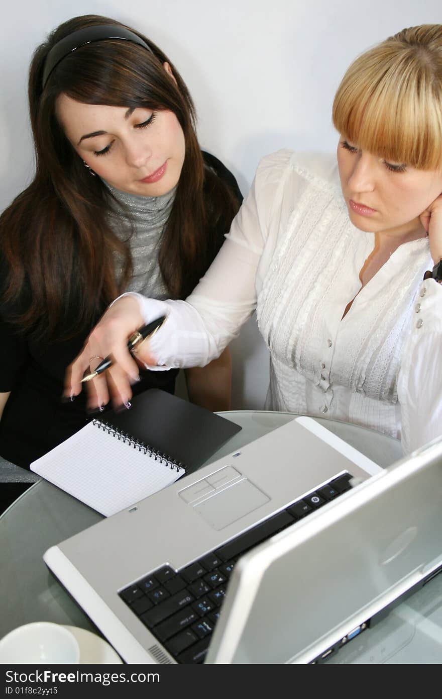 Two young business partners working in office. Two young business partners working in office.