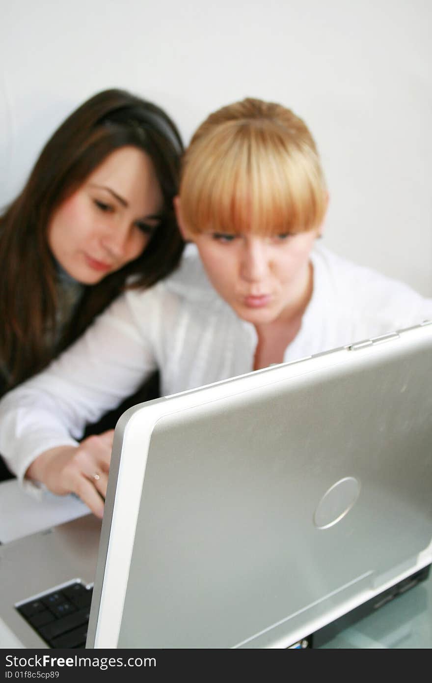 Two young business partners working in office. focus on a notebook. Two young business partners working in office. focus on a notebook