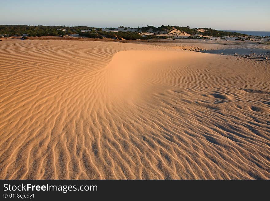 Sand dunes during sunset, dramatic shadow play at Stockton dunes in Anna Bay, NSW, Australia. Sand dunes during sunset, dramatic shadow play at Stockton dunes in Anna Bay, NSW, Australia