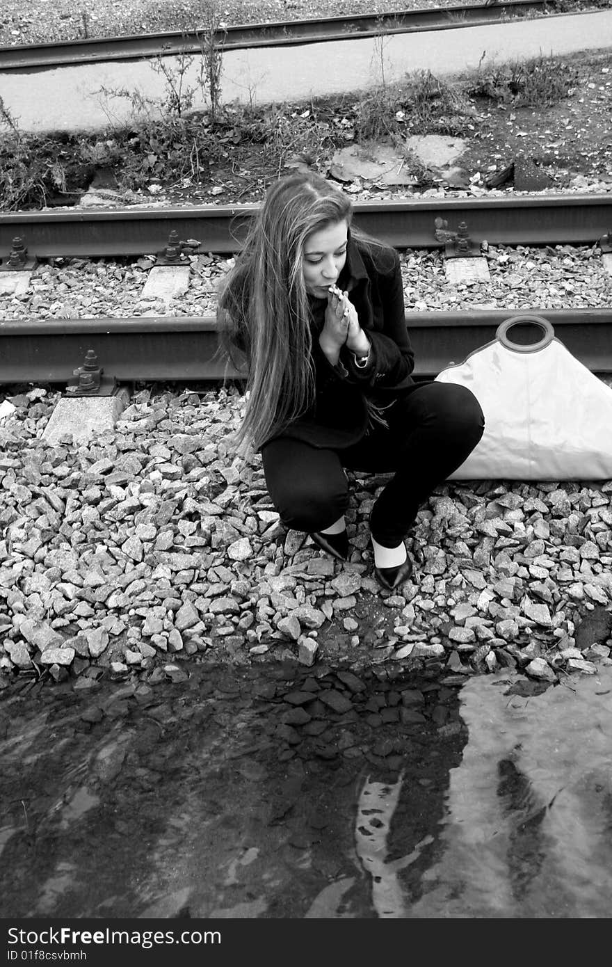 Girl sitting near water