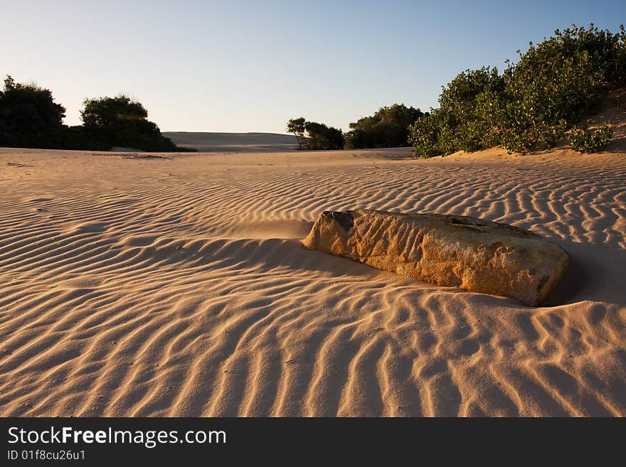 Sand dunes during sunset, dramatic shadow play at Stockton dunes in Anna Bay, NSW, Australia. Sand dunes during sunset, dramatic shadow play at Stockton dunes in Anna Bay, NSW, Australia