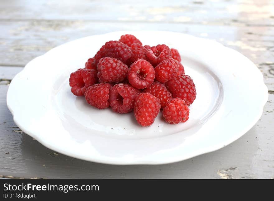 Raspberries on a White Dish