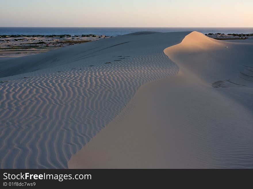 Sand dunes during sunset, dramatic shadow play at Stockton dunes in Anna Bay, NSW, Australia