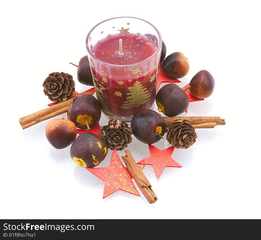 New Year's candle in an environment of apples, strobiles und stars on white background