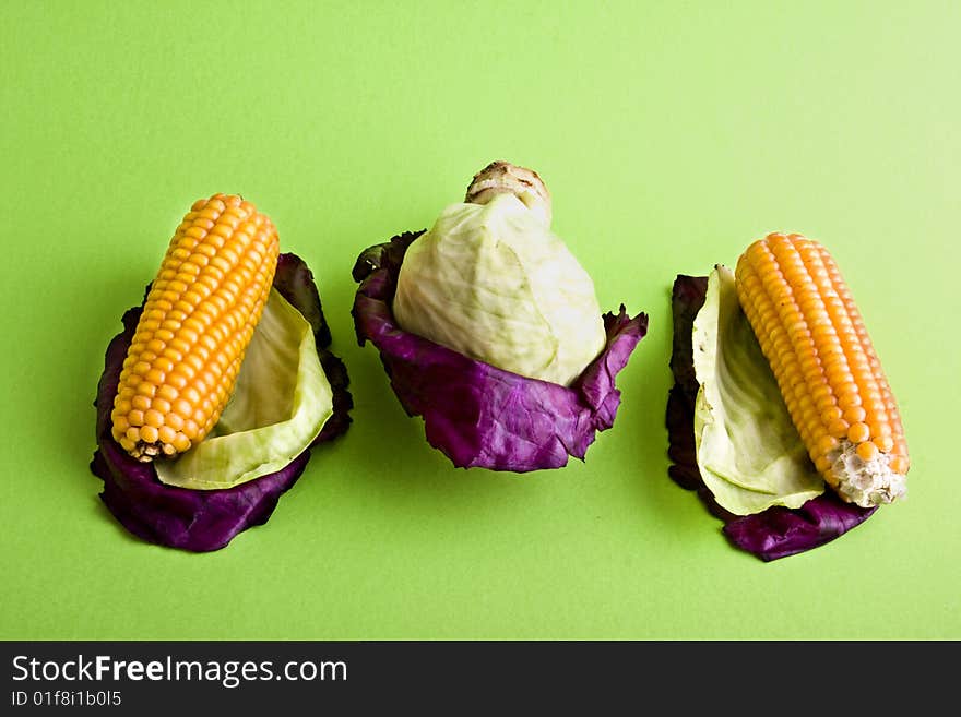 Corn and cabbage cloe-up isolated on a green background