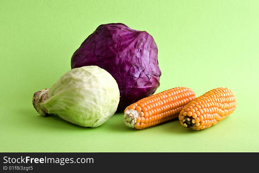 Corn and cabbage cloe-up isolated on a green background