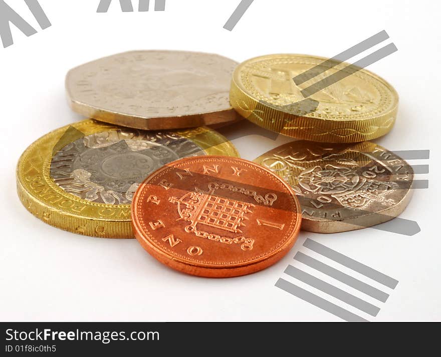 Clock face overlaid over pile of UK coins. Clock face overlaid over pile of UK coins