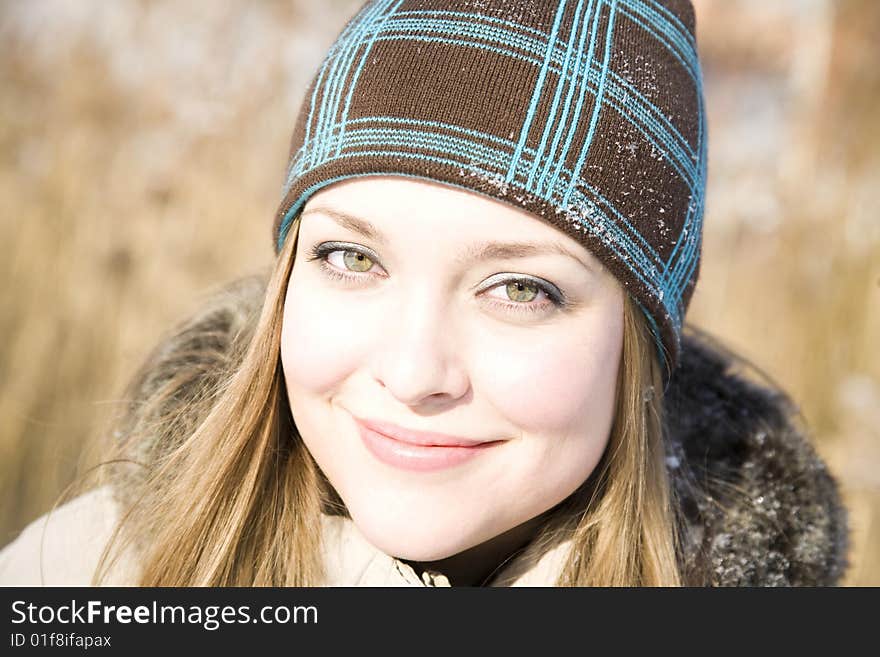 Beautiful Woman Close-Up Portrait On The Nature Background