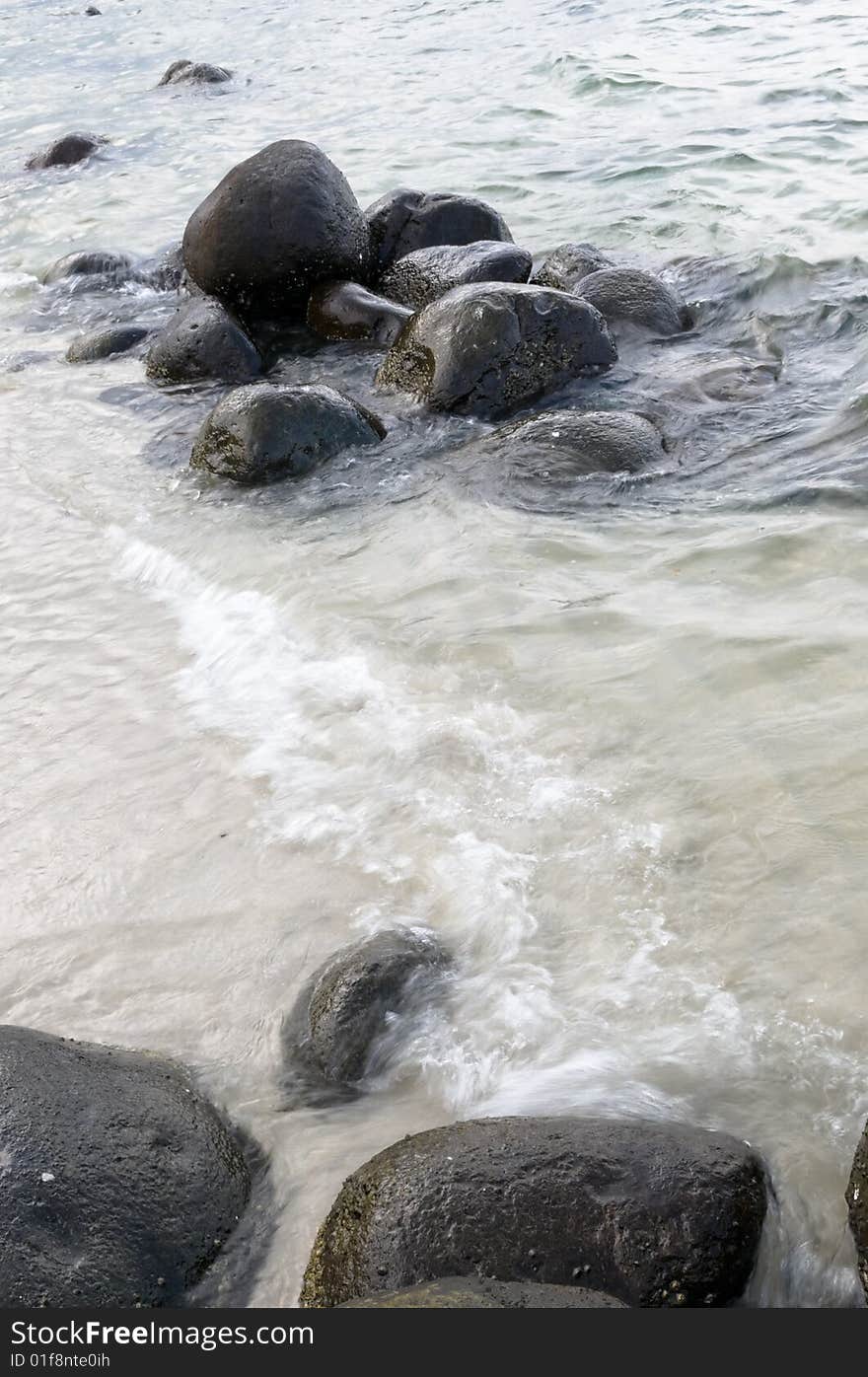 Sea breaking up on the rocks of a rocky seashore. Sea breaking up on the rocks of a rocky seashore