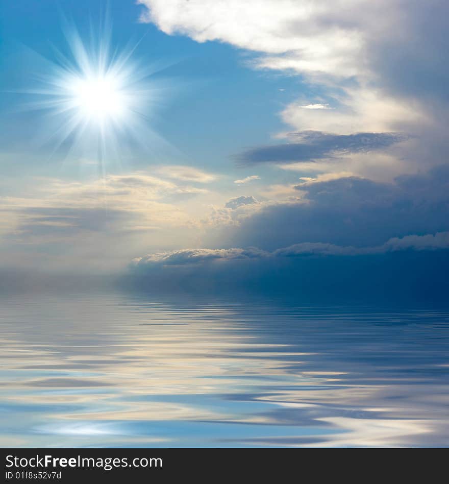 Blue sky over water and bright sun