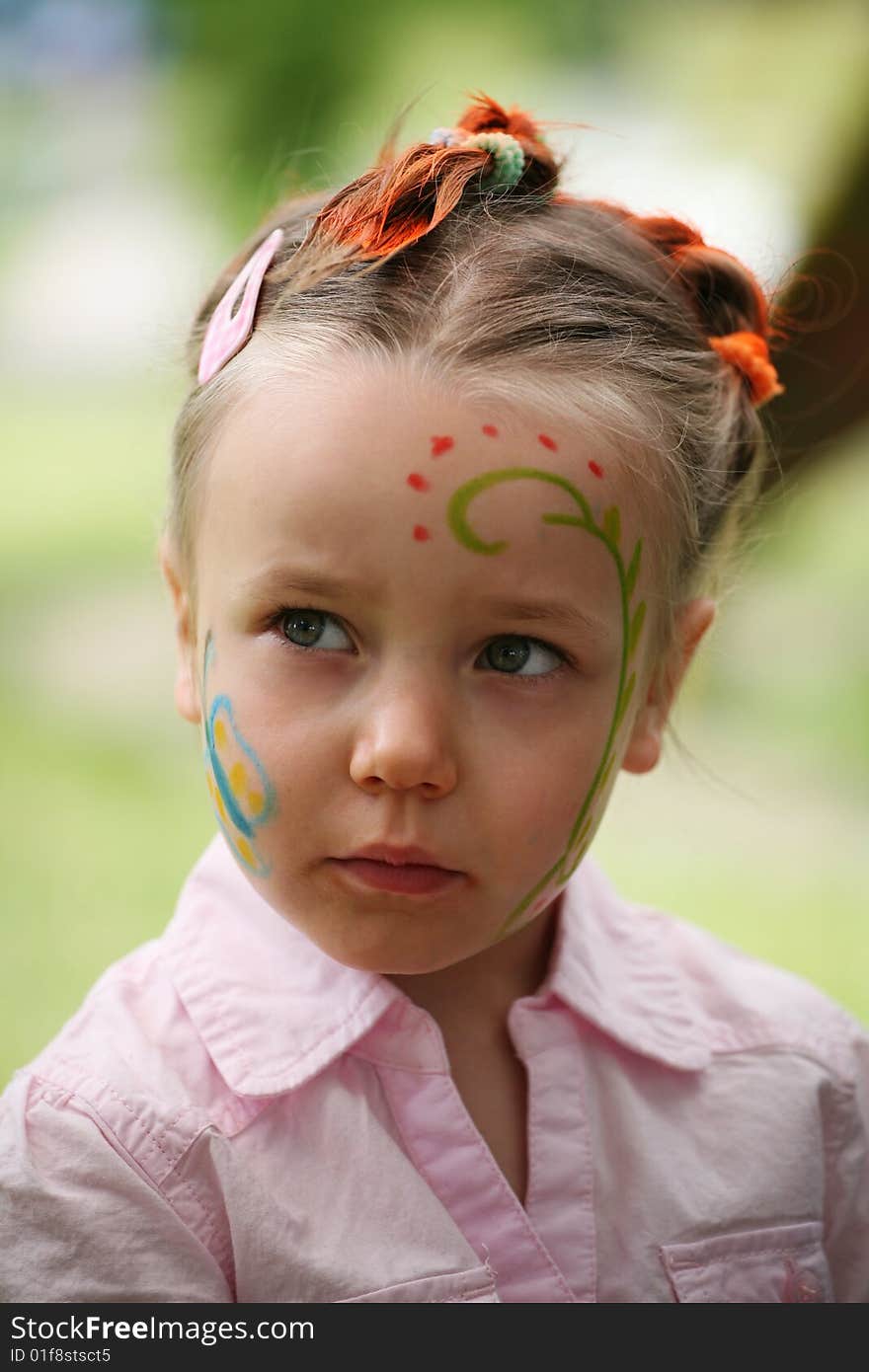 Cute outdoor portrait of five years old girl with face and hair painted. Cute outdoor portrait of five years old girl with face and hair painted.