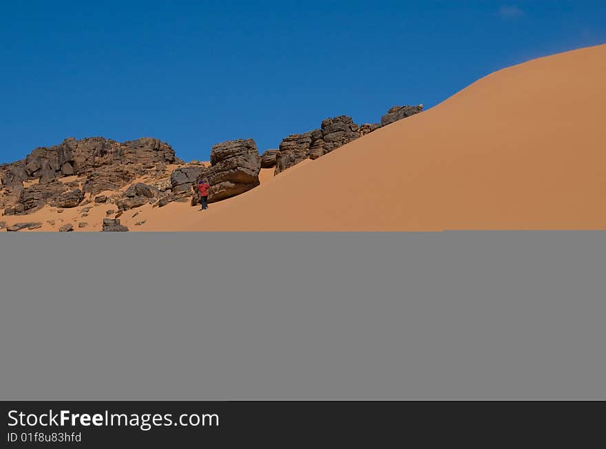 Dune and rock in blue sky desert