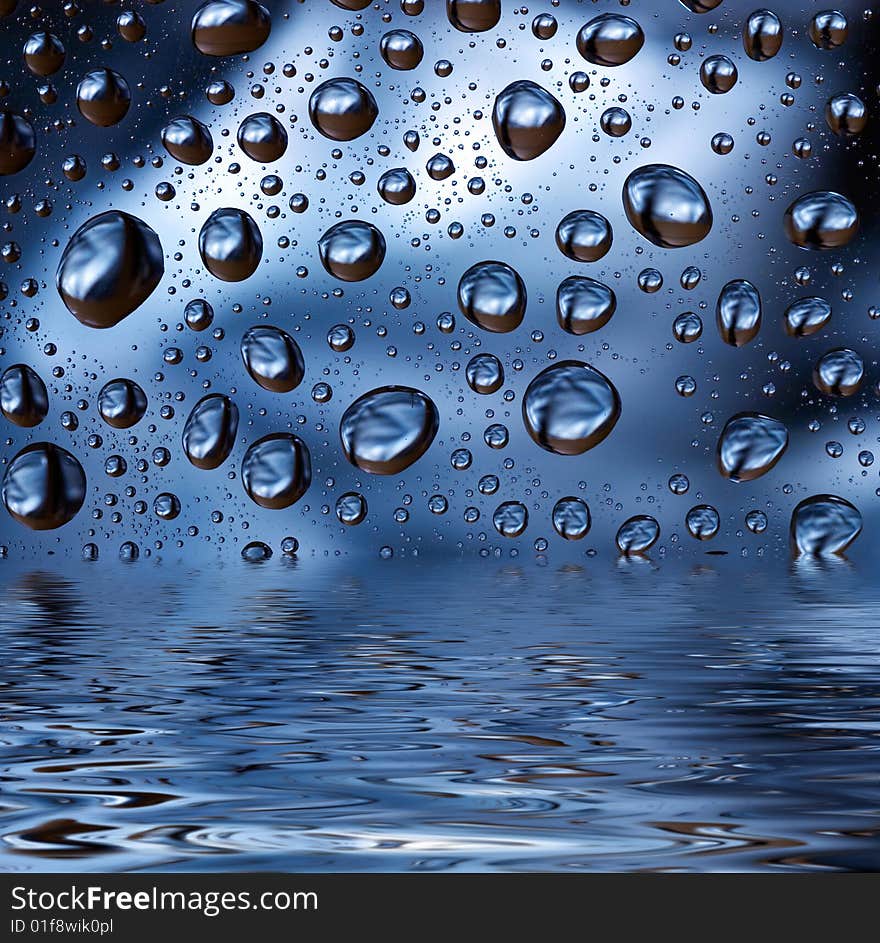 Water droplets on blue background reflected in water