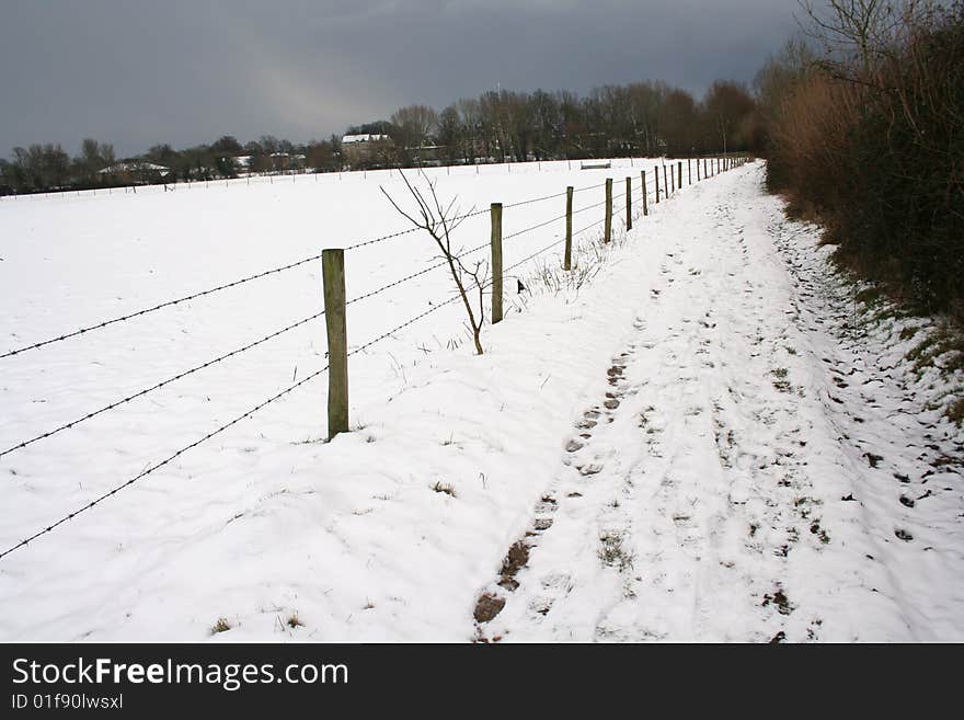 Field of snow, with barbed fence and path. Field of snow, with barbed fence and path