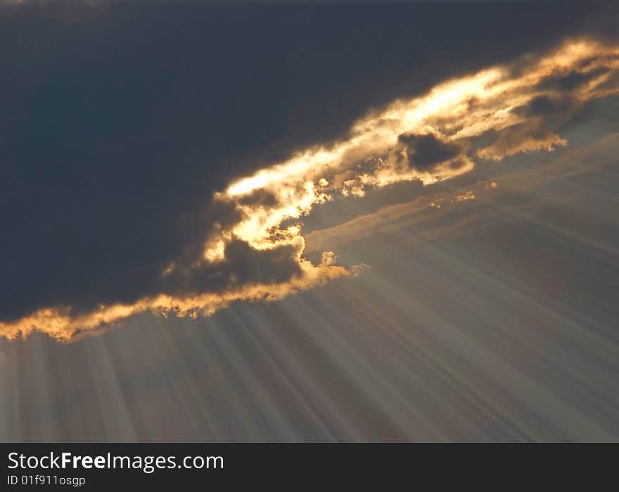 Dark dramatic sky with sun rays