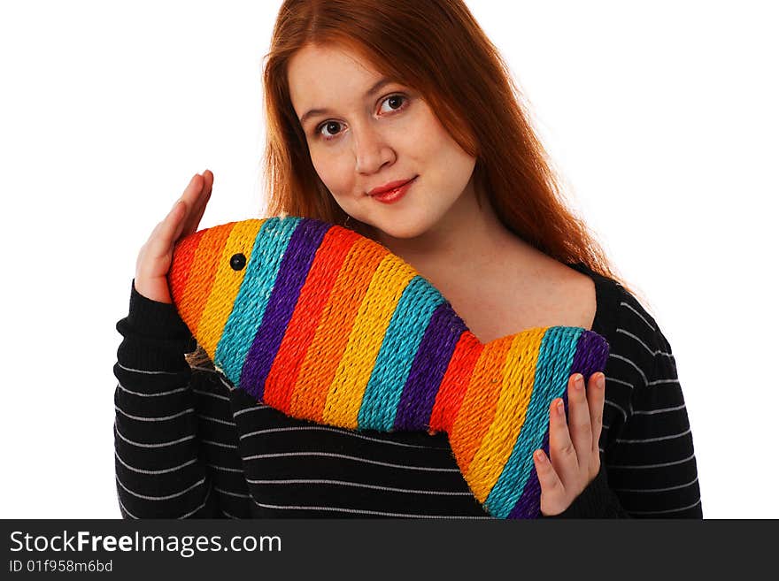 The young woman with a toy rainbow fish on a white background