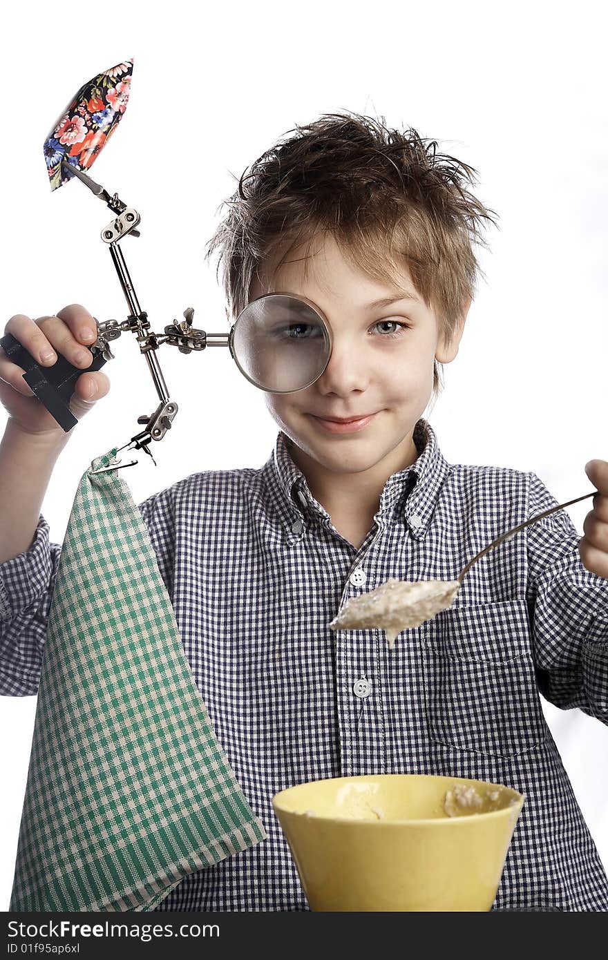 A boy with  a magniglass eating a sweet and porridge. A boy with  a magniglass eating a sweet and porridge