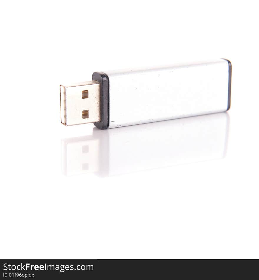 Isolated shot of a silver USB stick. The stick is mirrored and isolated over pure white. Lot of copyspace.