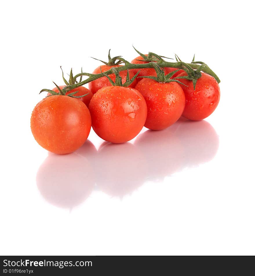 Macroshot of a bunch of tomatoes with drops of water. Isolated over white background. Lot of copyspace. Macroshot of a bunch of tomatoes with drops of water. Isolated over white background. Lot of copyspace.